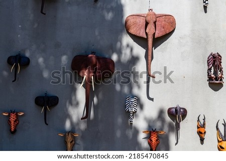 Wooden souvenir animal heads hanging on wall