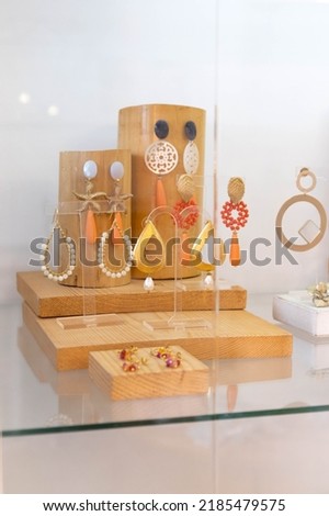 Earrings exhibitor with some bamboo displays ready to take the   handmade objects to a flea market to sell them Royalty-Free Stock Photo #2185479575