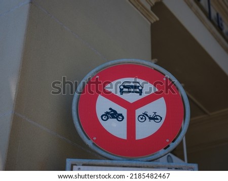 Road sign no entry of marked vehicles. red and white no passing sign for cars and motorcycles, by day, without persons in city