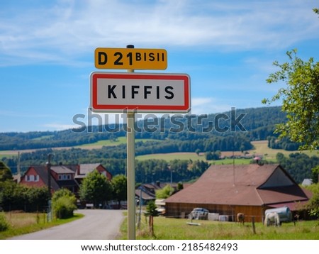 Road sign at entrance of French mountain village Kiffis on summer day.