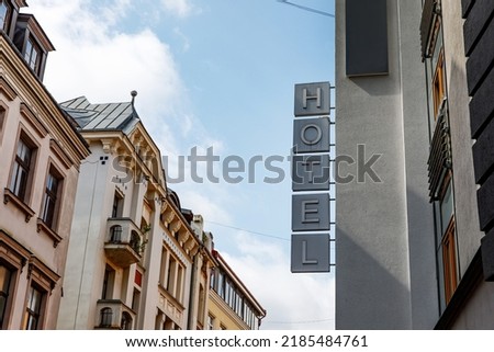 Hotel sign on the street. 5 separate letters