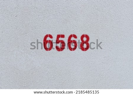 Red Number 6568 on the white wall. Spray paint.
