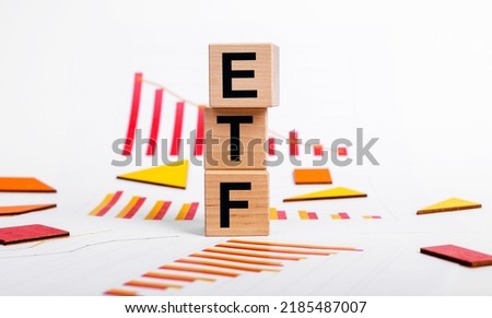 ETF investing fund. Acronym through magnifying glass. High quality photo