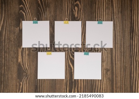 small square sheets for notes on a wooden background , September 1 concept