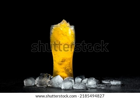 Homemade Frozen Beer Slushie Cocktail in a Glass with ice on black background
