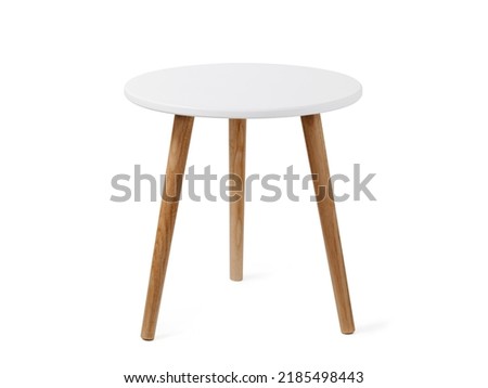 Round coffee table or end table in scandinavian style, isolated on white background with clipping path. Small round white table with 3 wooden legs on white background. Royalty-Free Stock Photo #2185498443