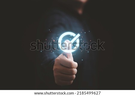Businessman hand thumb up with virtual correct sign or tick mark for approve quality assurance and guarantee concept. Royalty-Free Stock Photo #2185499627