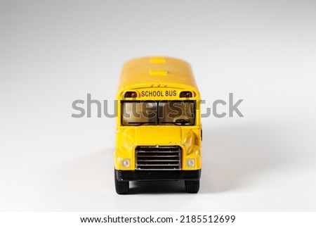 Toy model of yellow Bus over white background. Vintage generic transport toy. School bus