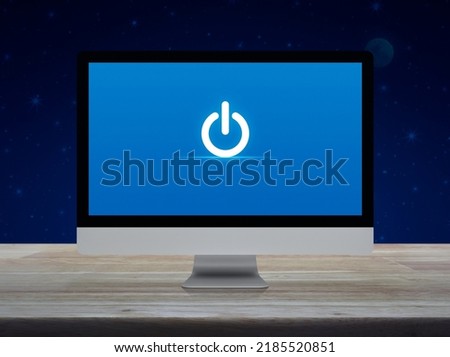 Power button icon on desktop modern computer monitor screen on wooden table over fantasy night sky and moon, Business start up online concept