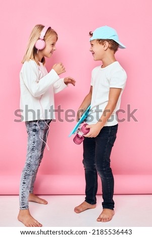 a boy in a cap and a girl smiling and listening to music in headphones lifestyle childhood