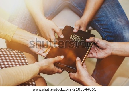 Three cristian friend hold bible and praying together with faith and trust or belief in God in small group fellowship . Power of hope or love, christian devotion background, bible study group  concept Royalty-Free Stock Photo #2185544051