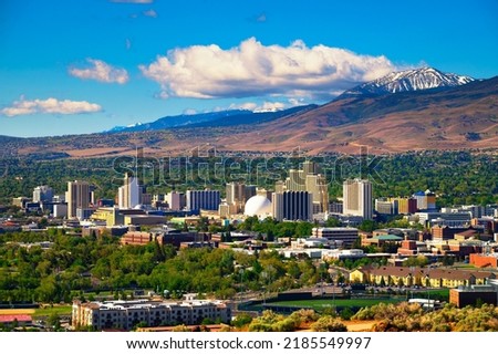 Downtown Reno skyline, Nevada, with hotels, casinos and the surrounding High Eastern Sierra foothills Royalty-Free Stock Photo #2185549997