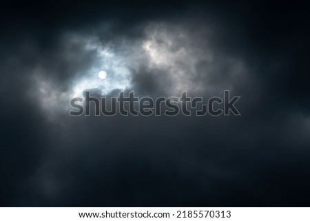 Dark storm clouds block the light of the sun. Background picture. Atmospheric phenomenon.