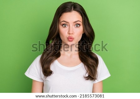 Photo of cute impressed young lady wear white t-shirt lips pouted isolated green color background