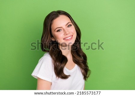 Photo of pretty adorable young lady wear white t-shirt smiling empty space isolated green color background