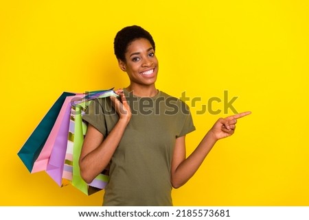 Portrait of cheerful nice person direct finger empty space proposition isolated on yellow color background