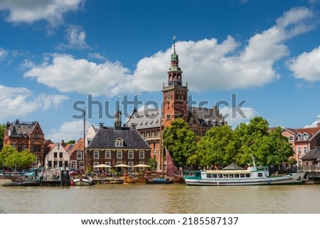 Leer, Germany. Panoramic view from Leda river on city hall, old weigh house in dutch classical baroque style, tourist harbor and bridge Royalty-Free Stock Photo #2185587137