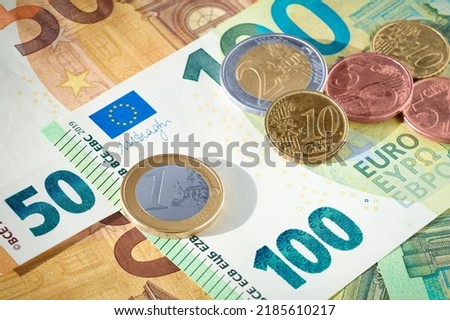 EU euro coins on heap of euro bills. EU economy and finance. Cash money. Currency background. Close up view. Royalty-Free Stock Photo #2185610217