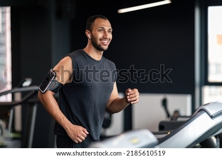 Portrait Of Handsome Black Male Athlete Exercising On Treadmill At Gym, Smiling Young African American Man Jogging Indoors, Practicing Sports On Modern Equipment In Fitness Club, Copy Space Royalty-Free Stock Photo #2185610519