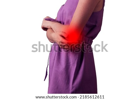 young woman experiencing pain in elbow joint on white background.