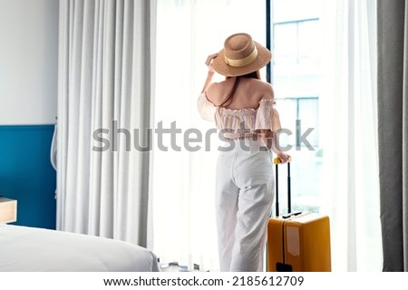 Tourist woman with luggage in hotel after check-in. Conceptual of travel and vacation. Royalty-Free Stock Photo #2185612709
