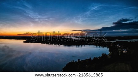 Aerial panorama Early Sunrise over Northern Sweden. Noctilucent night clouds, summer foggy lake reflects sky Royalty-Free Stock Photo #2185615885