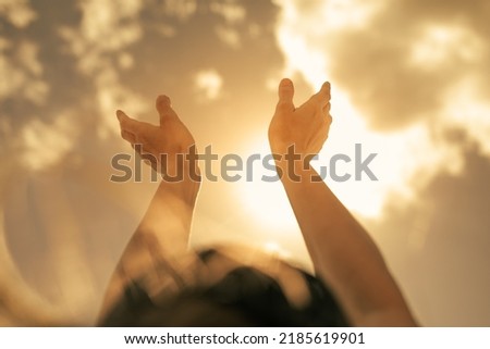Woman's hands reaching up to the sunlight sunny sky. Feelings of hope, worship concept.  Royalty-Free Stock Photo #2185619901