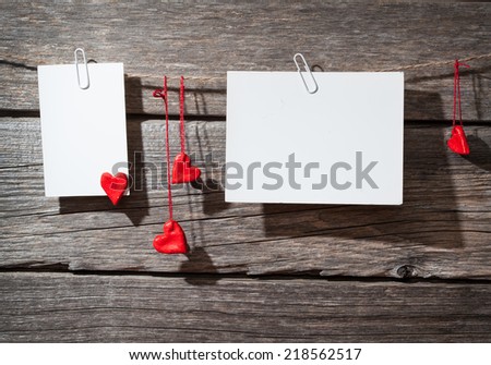 two paper clips on a wooden background