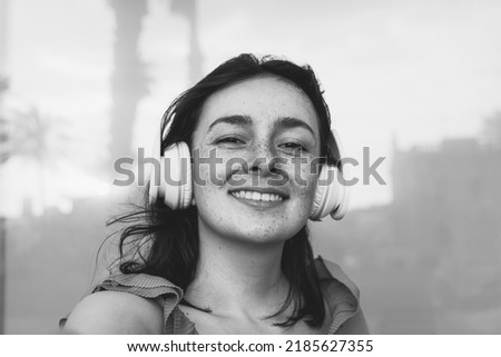 Happy latin girl having fun making selfie portrait outdoor - Focus on face