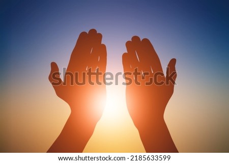 A hand silhouette sunlight. christian business love religion concept. christianity and religion belief in god. Royalty-Free Stock Photo #2185633599