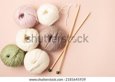 Craft hobby background with yarn in natural colors. Recomforting hobby to reduce stress for cold fall and winter weather. Mock up, copy space, top view Royalty-Free Stock Photo #2185645939