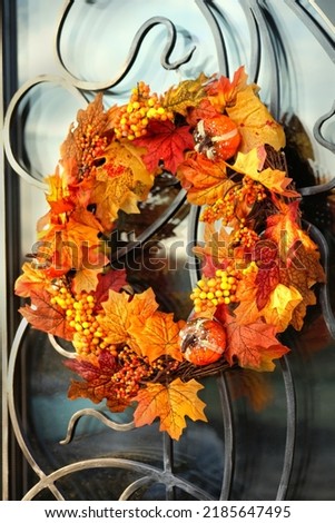 Autumn background. Decorative bright autumnal wreath hanging on house door. Beautiful Festive decor for Thanksgiving holiday, Halloween party. symbol of Fall season.