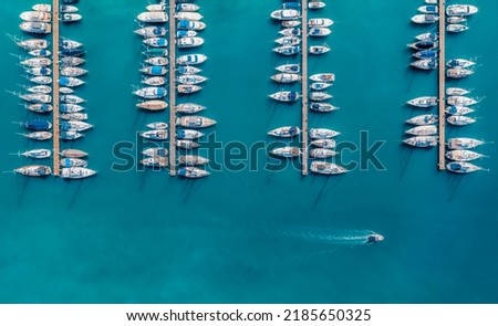 Aerial view of luxure yachts and motorboats moored in a port with clear blue water in summer. Top view from drone of sailboats and various speed boats in dock. Pula, Croatia Royalty-Free Stock Photo #2185650325