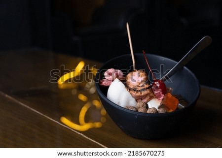 ice dessert with sweet toppings, Strawberry Bingsoo or Bingsu with soft focus, using as a background or wallpaper the dessert shows burnt marshmallow, colored cereal, chocolate cereal, panda-shaped