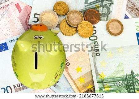 Classic Piggy Bank and money on the desk Royalty-Free Stock Photo #2185677315