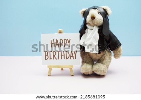 Happy Birthday text message with cute teddy bear on blue and pink background