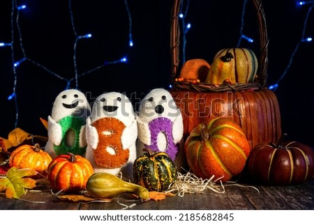 Festive Halloween image. Pumpkins, autumn leaves, boo dolls. The concept of horror stories and holiday.