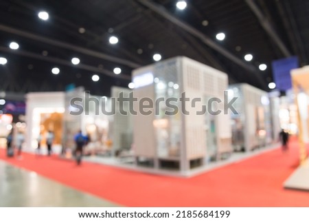 Abstract blur people in exhibition hall event trade show expo background. Home furniture fair expo, business marketing and event fair organizer concept. Royalty-Free Stock Photo #2185684199