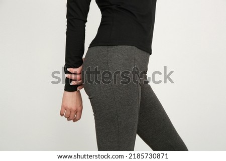 Serie of studio photos of young female model wearing stretch viscose turtleneck and basic flared trousers.	