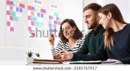 Young business people with laptop working in office. Agile concept Royalty-Free Stock Photo #2185767017