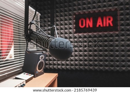 Professional microphone in radio station studio and on air sign Royalty-Free Stock Photo #2185769439