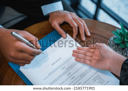 close up of businessman signing an agreement letter during meeting