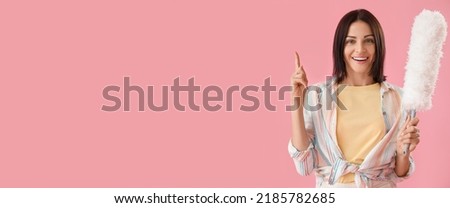 Young woman with pp-duster on pink background with space for text