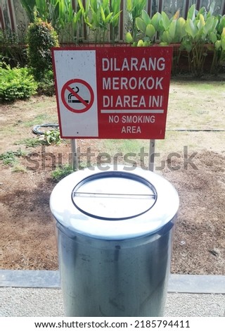 Garbage bin with a sign board"No Smoking Area" 