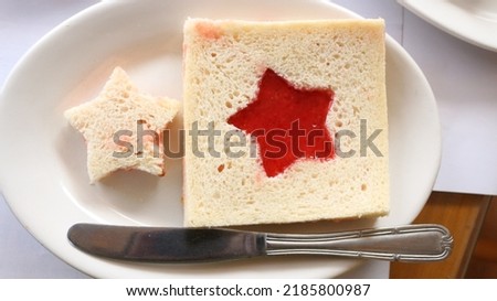 Delicious Bread with Jam in star shape with butter knife  Royalty-Free Stock Photo #2185800987