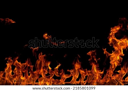 Fire creates infinity shapes when it burns. The orange from the flame and the black backgroud creates interesting textures. Flames from hell. Burning power. High quality photo