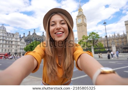 Holidays in UK. Brazilian girl takes selfie picture with smartphone in London, UK. Royalty-Free Stock Photo #2185805325