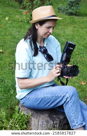 girl holding a professional camera in her hands