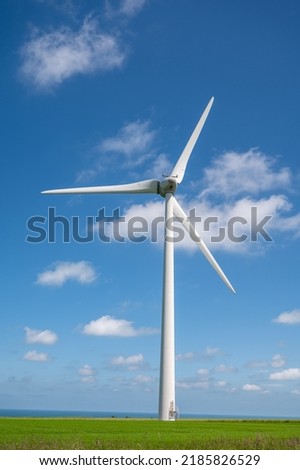 View on modern wind mills, green grain fields and blue Atlantic ocean in agricultural region Pays de Caux in Normandy, France in summer Royalty-Free Stock Photo #2185826529
