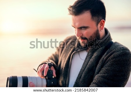 portrait photographer taking photos on the beach closeup